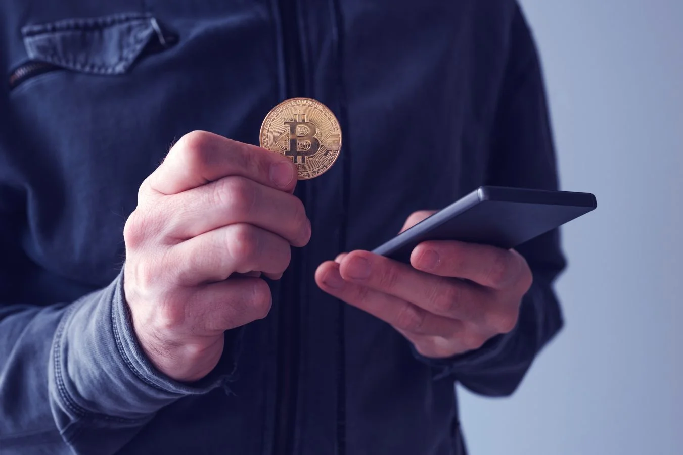  Man with bitcoin and mobile phone 
